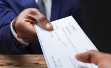 Employer handing a employee a paycheck that is long overdue.